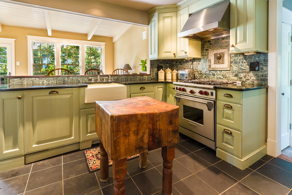 Design ideas for a traditional kitchen in Philadelphia with stainless steel appliances, a farmhouse sink, raised-panel cabinets, green cabinets and green splashback.