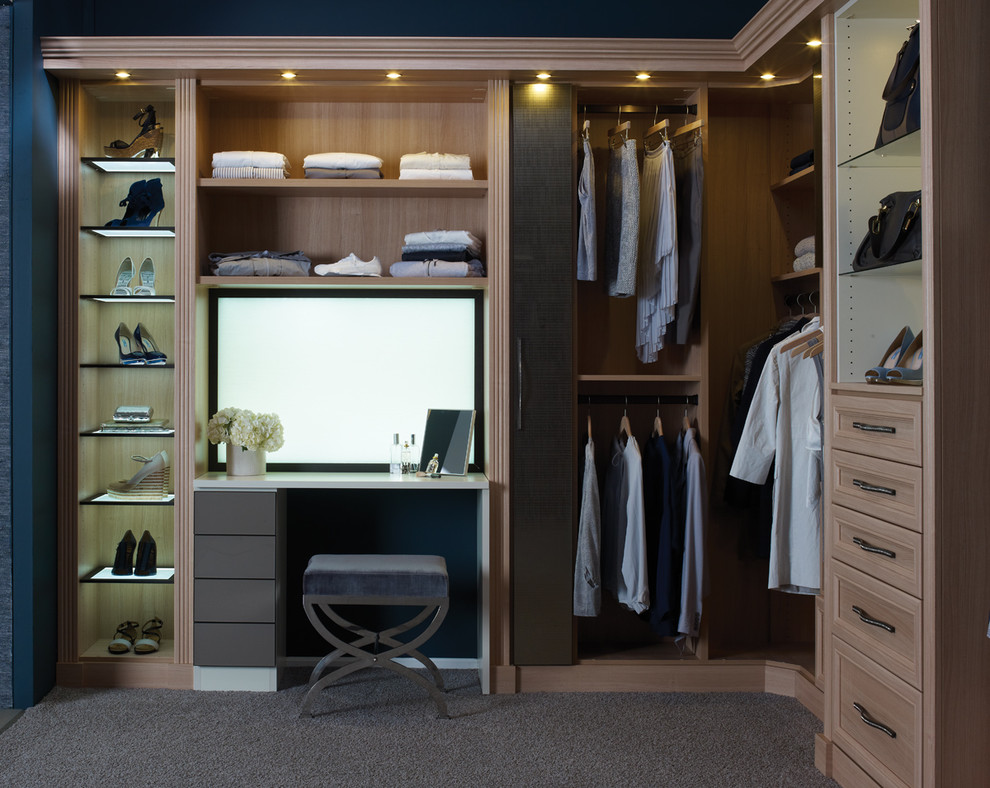 Large transitional gender-neutral walk-in wardrobe in San Francisco with raised-panel cabinets, light wood cabinets and carpet.