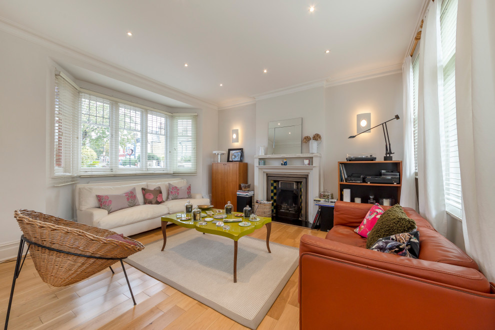 Eklektisches Wohnzimmer mit grauer Wandfarbe, braunem Holzboden, Kamin und braunem Boden in London