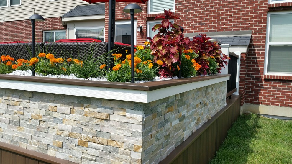 Example of a large classic backyard deck design with no cover
