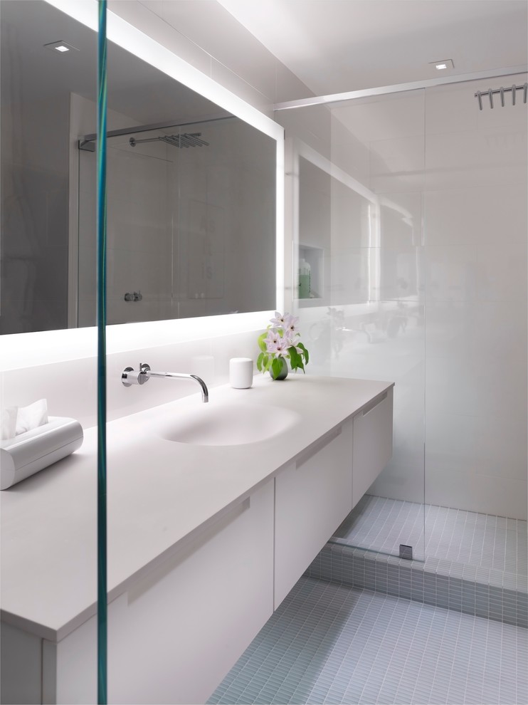 Alcove shower - large contemporary master gray tile and ceramic tile mosaic tile floor and gray floor alcove shower idea in San Francisco with an integrated sink, flat-panel cabinets, white cabinets, solid surface countertops, white walls and white countertops