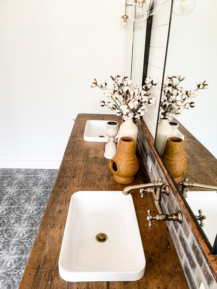 Example of a large transitional master porcelain tile, gray floor and double-sink freestanding bathtub design with light wood cabinets, a two-piece toilet, white walls, a drop-in sink, wood countertops, a hinged shower door, brown countertops and a freestanding vanity