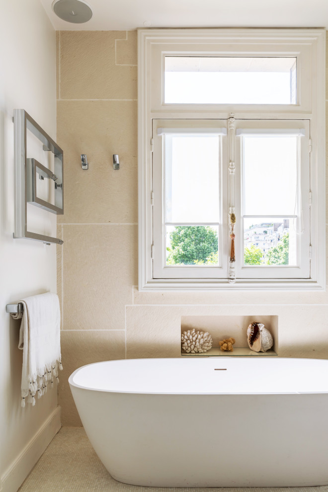 This is an example of a mid-sized contemporary master bathroom in Paris with a drop-in tub, an open shower, a wall-mount toilet, beige tile, terra-cotta tile, beige walls, mosaic tile floors, a wall-mount sink, beige floor, an open shower and a single vanity.