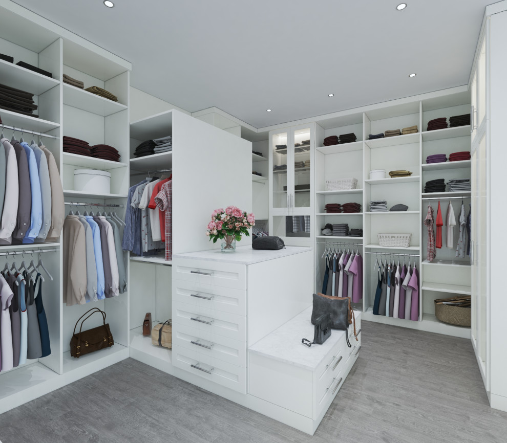 Photo of a large transitional women's walk-in wardrobe in Houston with shaker cabinets, white cabinets, light hardwood floors and brown floor.