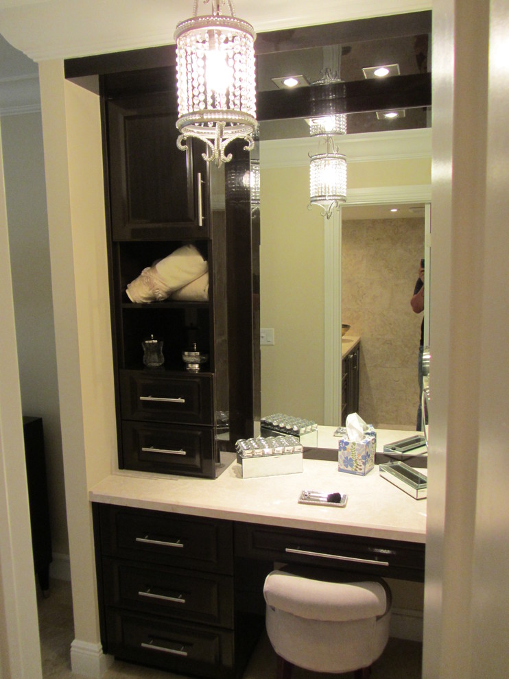 Example of a mid-sized transitional beige tile and porcelain tile porcelain tile powder room design in Miami with a vessel sink, raised-panel cabinets, dark wood cabinets, marble countertops, a two-piece toilet and beige walls