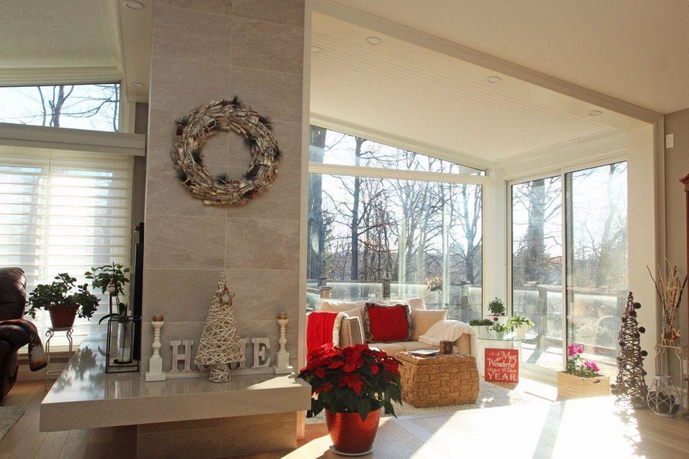 Large transitional sunroom in Other with a two-sided fireplace, a standard ceiling and beige floor.