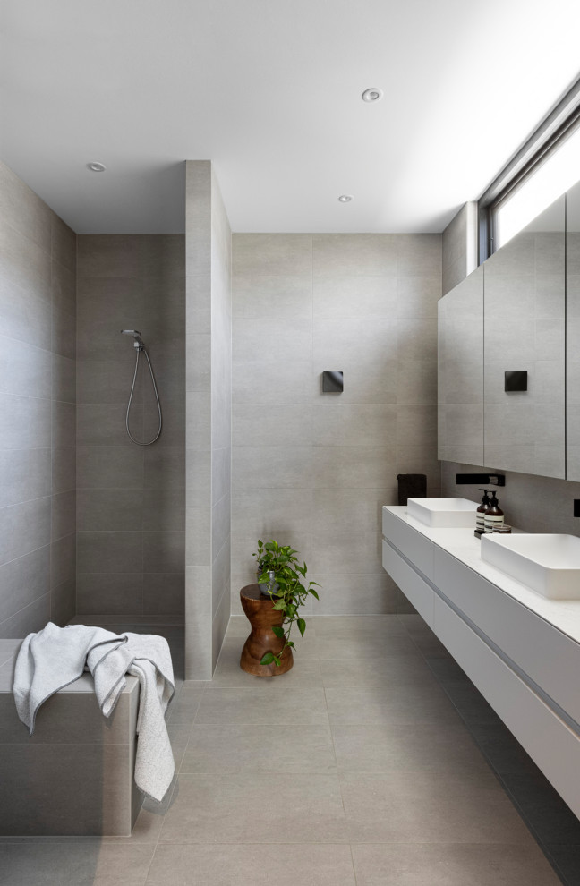 Design ideas for a large modern master bathroom in Melbourne with flat-panel cabinets, white cabinets, an open shower, gray tile, ceramic tile, ceramic floors, engineered quartz benchtops, grey floor, an open shower, white benchtops, a shower seat, a double vanity and a floating vanity.