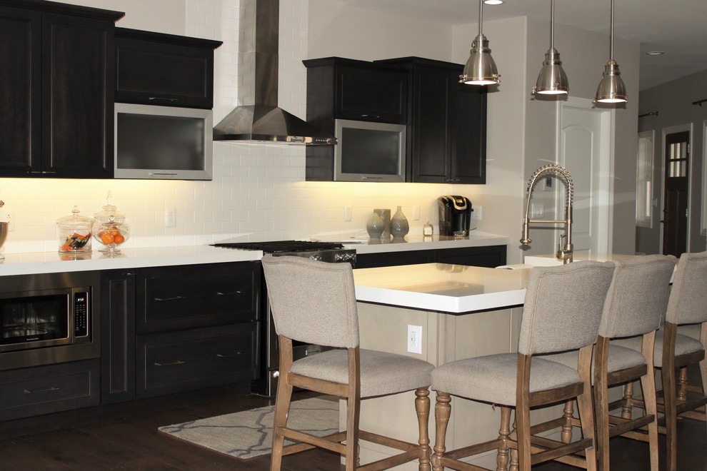 Kitchen - mid-sized transitional medium tone wood floor kitchen idea in Chicago with quartzite countertops, white backsplash, stainless steel appliances, an island, a farmhouse sink, recessed-panel cabinets and ceramic backsplash