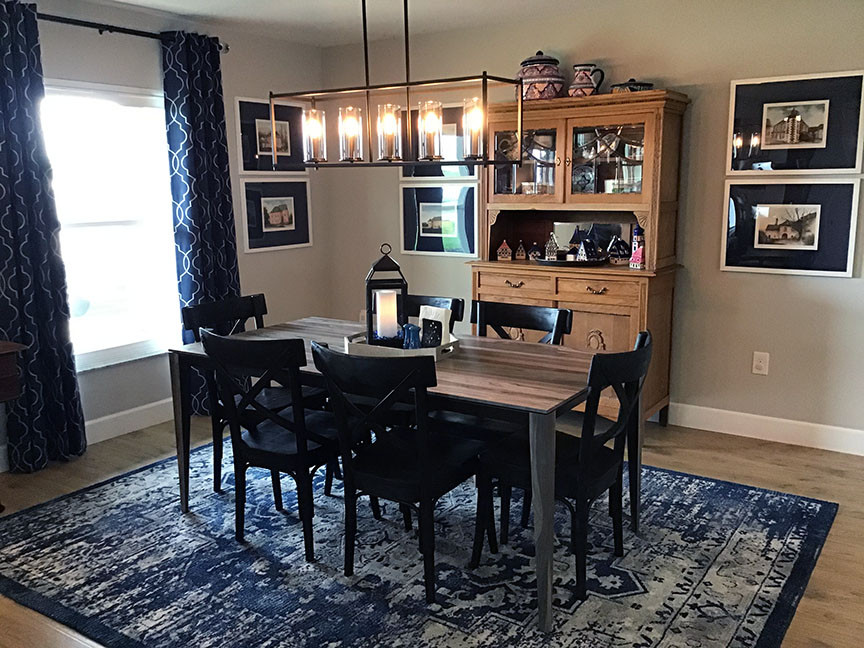 Photo of a large transitional open plan dining in Orlando with grey walls, laminate floors, no fireplace and beige floor.