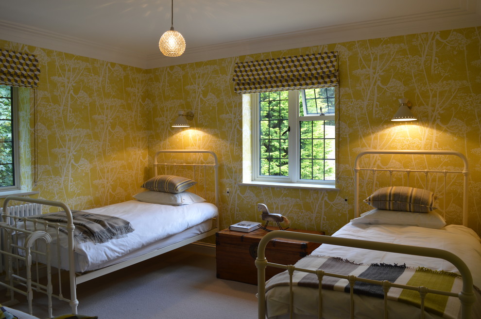 Photo of a mid-sized traditional guest bedroom in London with yellow walls and carpet.