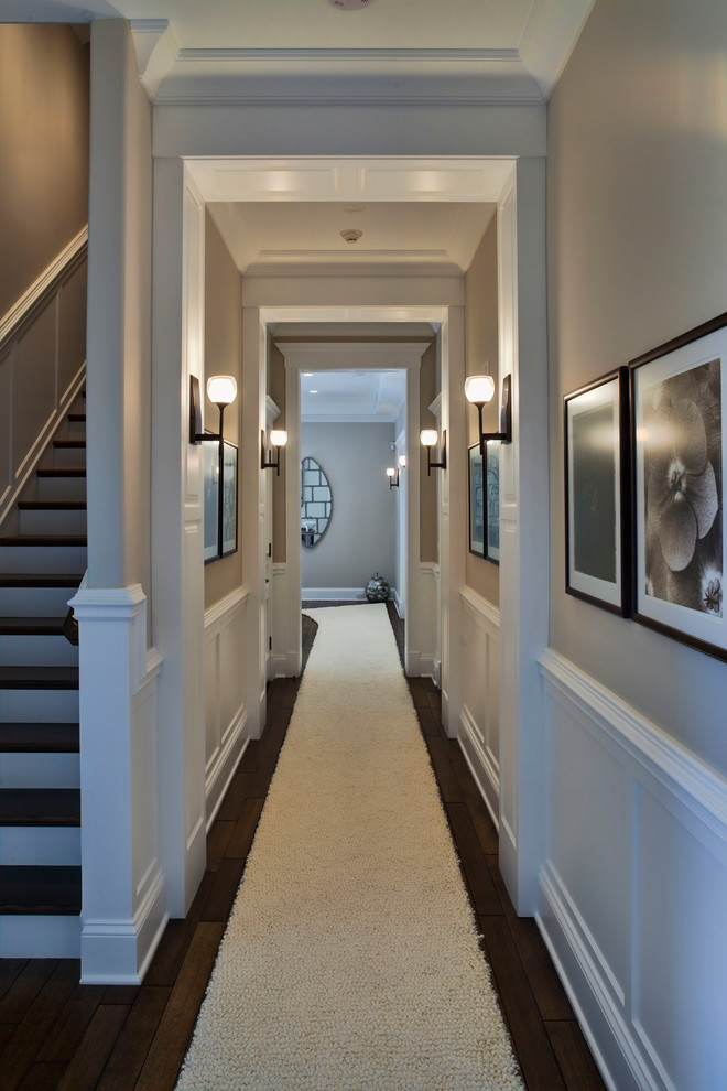 This is an example of a mid-sized transitional hallway in Chicago with beige walls and dark hardwood floors.