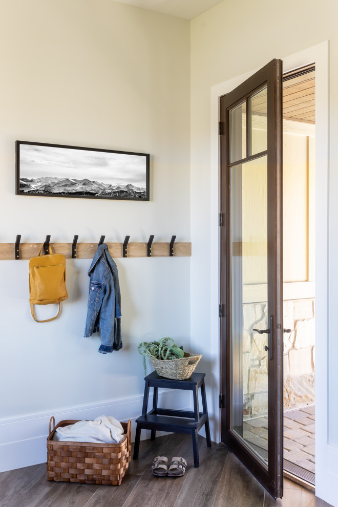 Inspiration for a farmhouse dark wood floor and brown floor hallway remodel in Salt Lake City with beige walls
