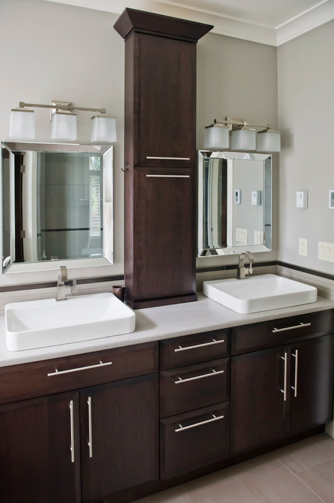 This is an example of a small transitional bathroom in Vancouver with a vessel sink, dark wood cabinets, laminate benchtops, beige tile and beige walls.
