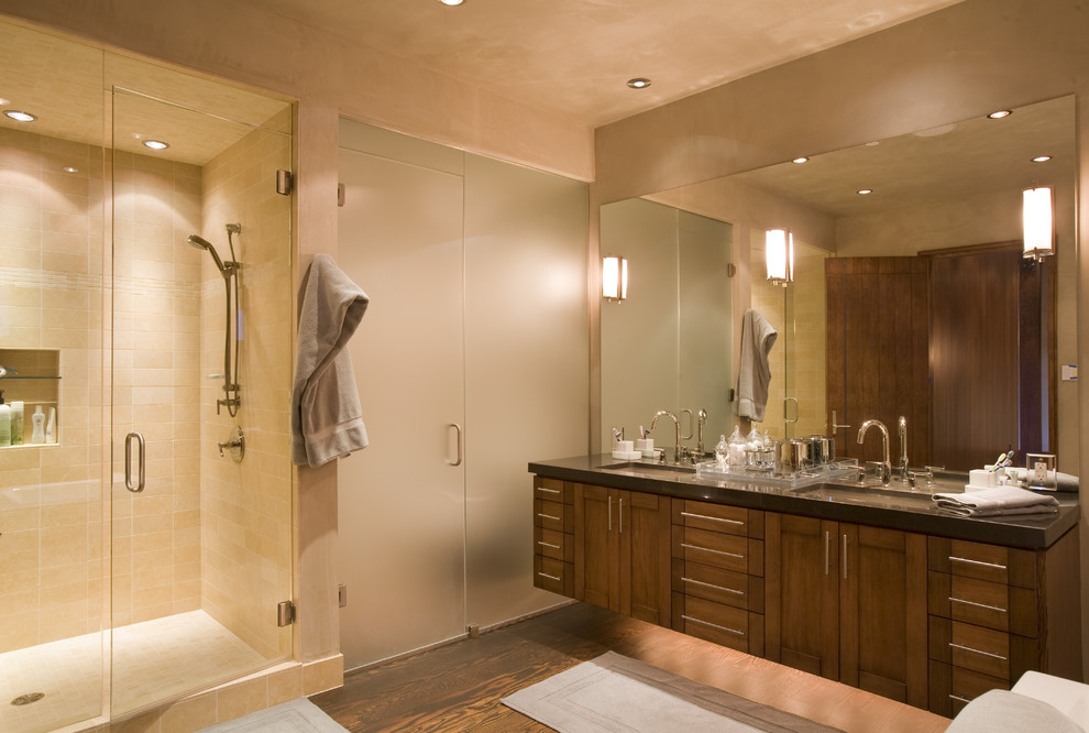 Design ideas for a contemporary bathroom in Denver with an undermount sink, shaker cabinets, dark wood cabinets, an alcove shower and beige tile.