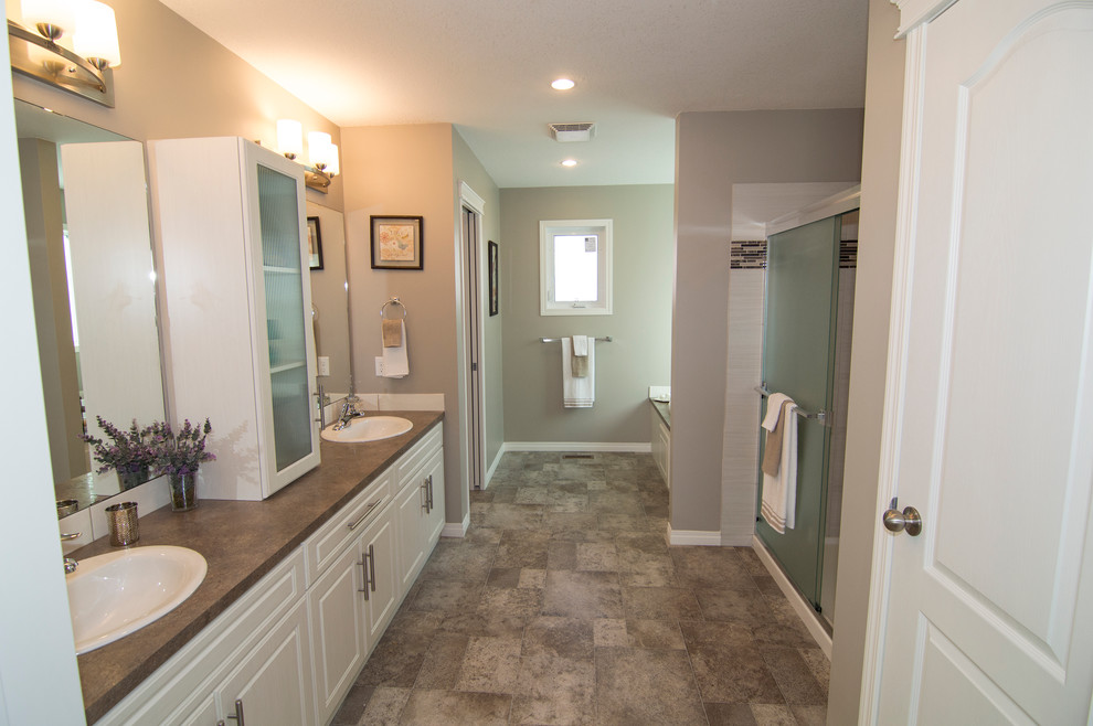 Large contemporary master bathroom in Calgary with a drop-in sink, raised-panel cabinets, white cabinets, laminate benchtops, a drop-in tub, an open shower, a one-piece toilet, yellow tile, subway tile, beige walls and linoleum floors.