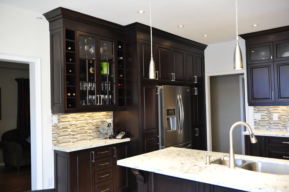 Inspiration for a mid-sized transitional u-shaped eat-in kitchen remodel in Toronto with a double-bowl sink, raised-panel cabinets, dark wood cabinets, quartz countertops, multicolored backsplash, matchstick tile backsplash, stainless steel appliances and a peninsula