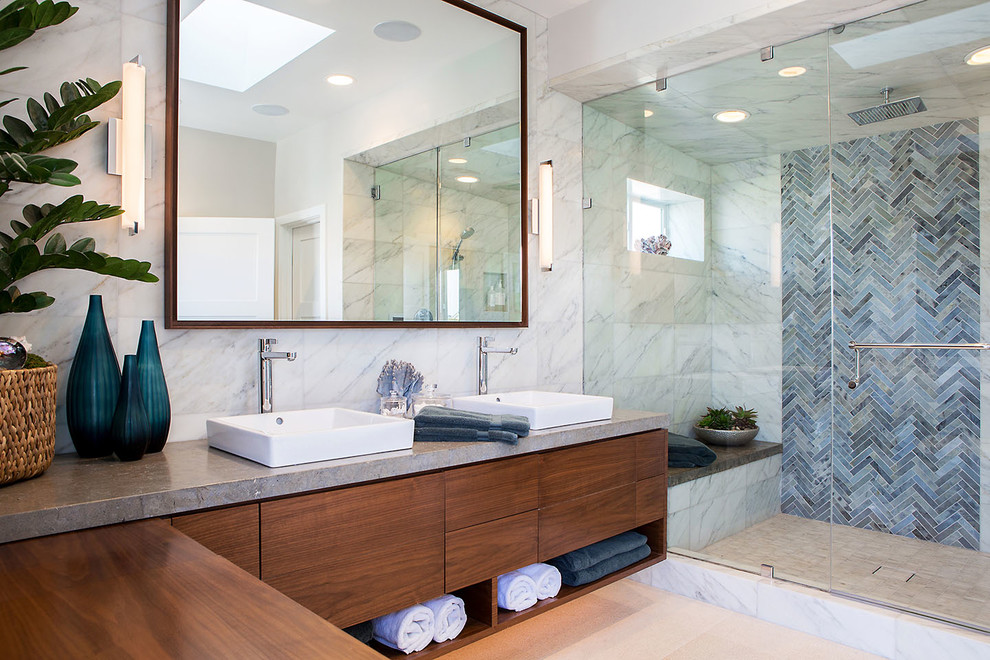 This is an example of a contemporary bathroom in Los Angeles with flat-panel cabinets, dark wood cabinets, an alcove shower, blue tile, a vessel sink, beige floor and a hinged shower door.