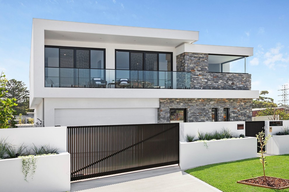 Contemporary two-storey white house exterior in Sydney with a flat roof, a metal roof and mixed siding.