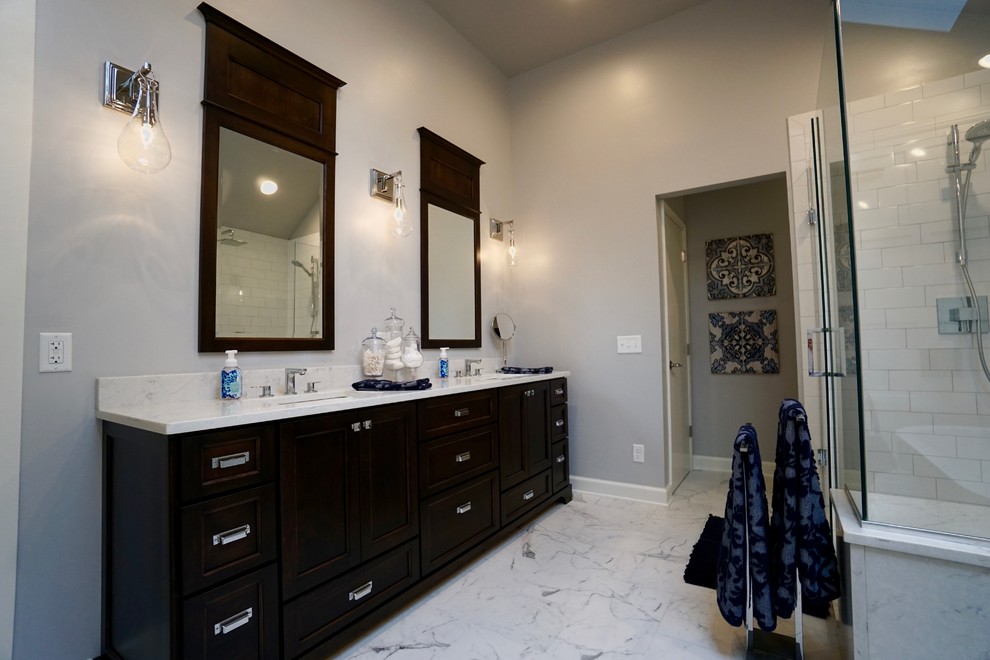 Inspiration for a large contemporary master bathroom in Columbus with shaker cabinets, dark wood cabinets, a freestanding tub, an open shower, white tile, subway tile, grey walls, ceramic floors, an undermount sink and quartzite benchtops.