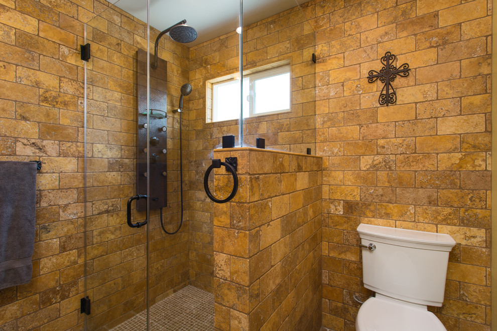 Inspiration for a mid-sized master bathroom in Los Angeles with furniture-like cabinets, distressed cabinets, a curbless shower, a two-piece toilet, yellow tile, travertine, beige walls, travertine floors, a vessel sink, wood benchtops, beige floor and a hinged shower door.