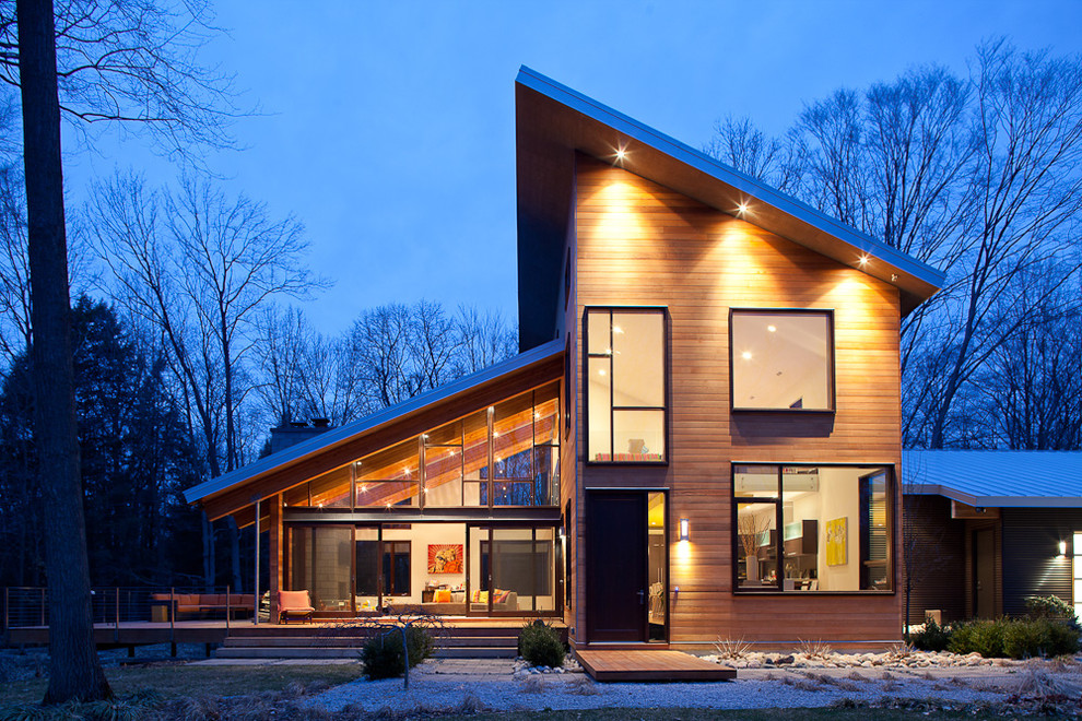 Inspiration for a contemporary exterior in Grand Rapids with wood siding and a shed roof.