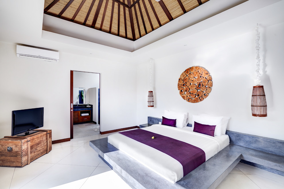 Photo of a tropical master bedroom in Other with white walls.