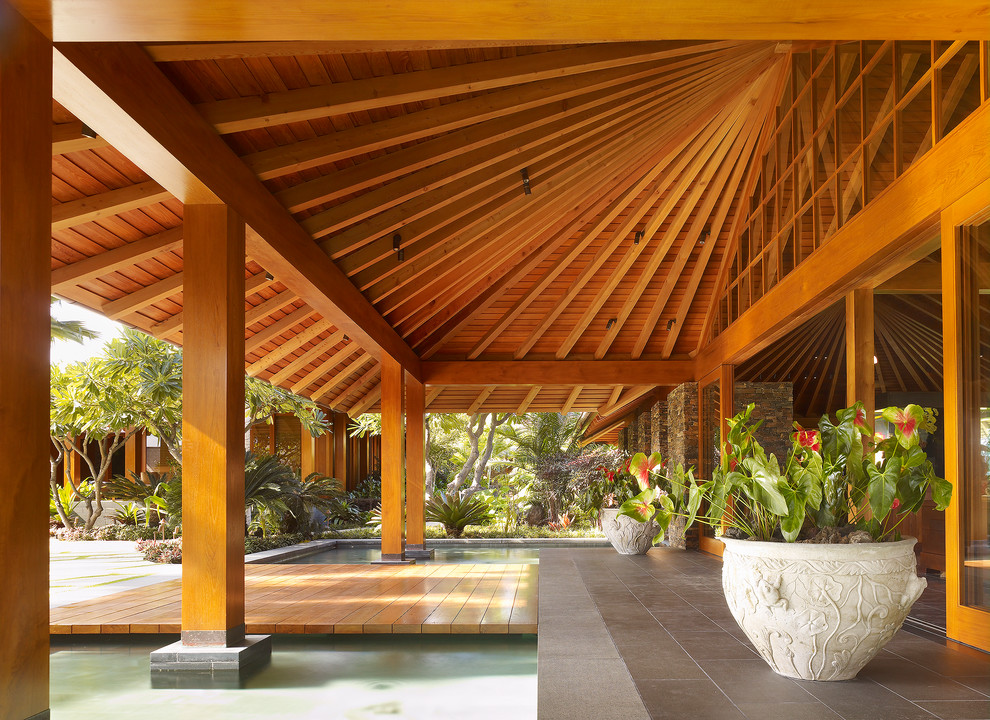 Design ideas for a tropical patio in San Francisco with a roof extension.