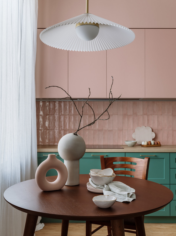 Esempio di una cucina minimalista di medie dimensioni con lavello da incasso, ante verdi, paraspruzzi rosa, paraspruzzi con piastrelle in ceramica, elettrodomestici neri e nessuna isola