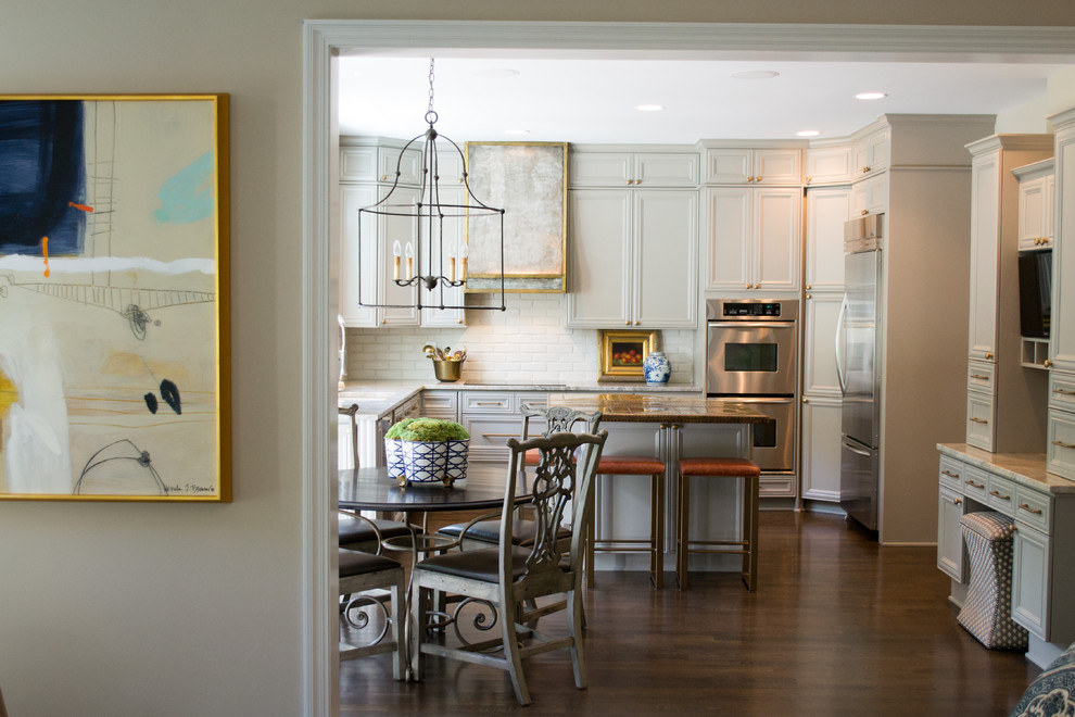 Inspiration for a mid-sized transitional dark wood floor and brown floor kitchen remodel in Columbus with white backsplash, stainless steel appliances and an island
