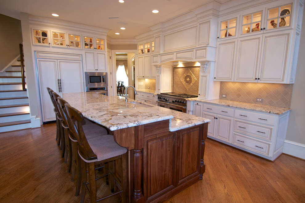 Inspiration for a large traditional eat-in kitchen in Raleigh with an undermount sink, raised-panel cabinets, distressed cabinets, granite benchtops, panelled appliances and with island.