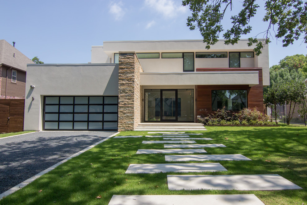Mid-sized midcentury two-storey stucco white house exterior in Dallas with a flat roof.