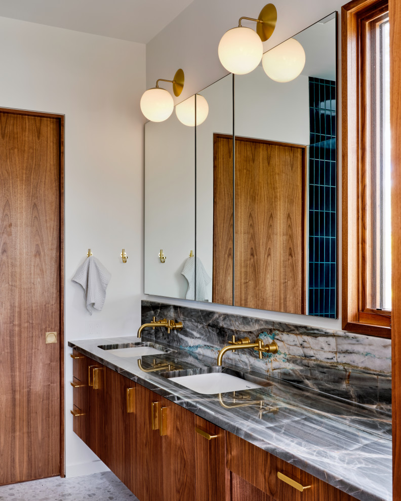 Photo of a small modern bathroom in Austin with flat-panel cabinets, dark wood cabinets, a freestanding tub, a curbless shower, a wall-mount toilet, green tile, ceramic tile, terrazzo floors, an undermount sink, quartzite benchtops, a hinged shower door, a double vanity and a floating vanity.