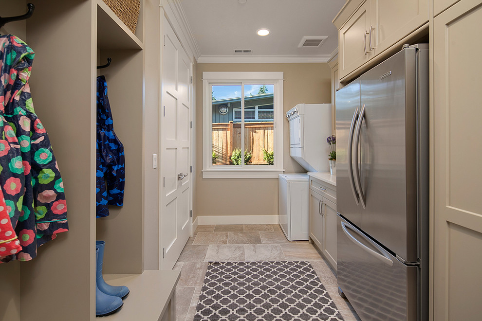 Contemporary galley utility room in Seattle with recessed-panel cabinets, grey cabinets, quartz benchtops, beige walls, porcelain floors and a stacked washer and dryer.