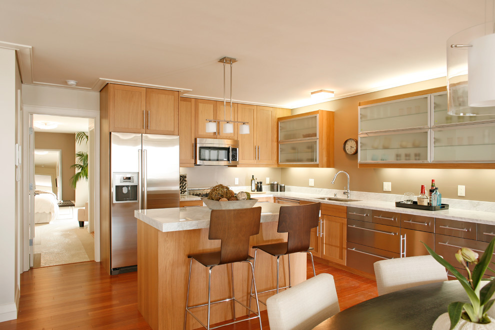 Inspiration for a mid-sized contemporary l-shaped eat-in kitchen in San Francisco with stainless steel appliances, medium wood cabinets, an undermount sink, recessed-panel cabinets, quartzite benchtops, beige splashback, medium hardwood floors and with island.