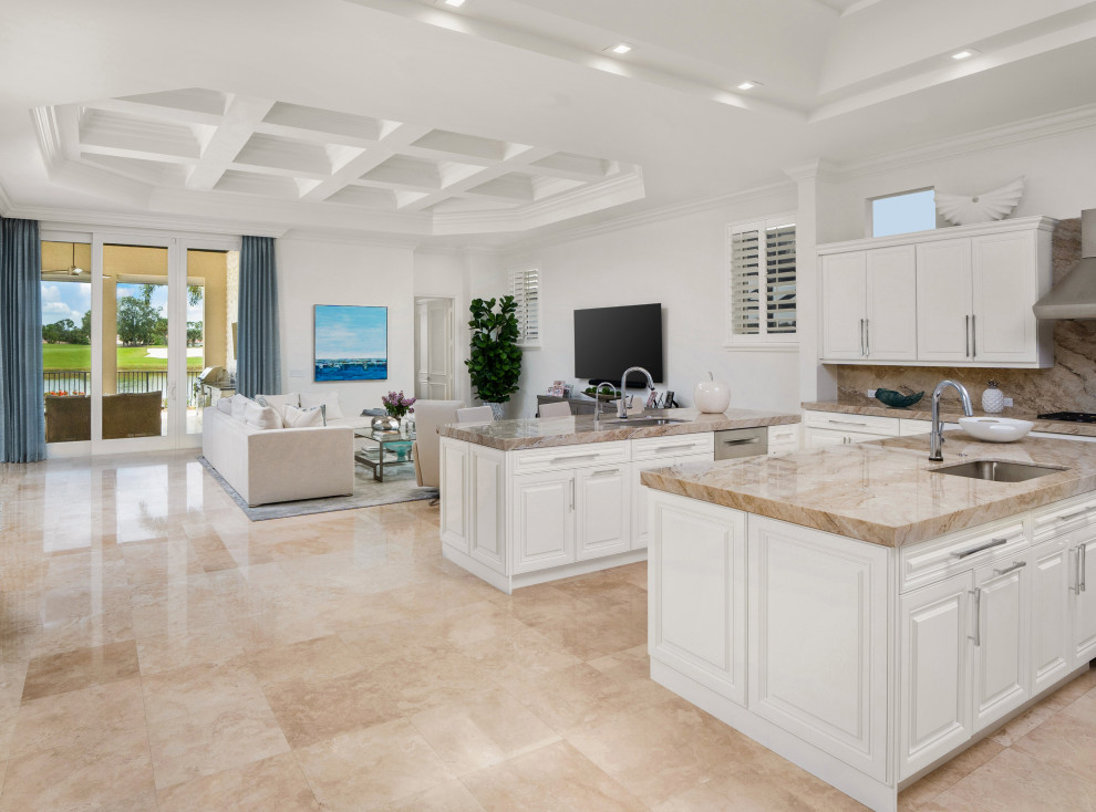 Expansive mediterranean u-shaped kitchen in Miami with a submerged sink, raised-panel cabinets, white cabinets, marble worktops, beige splashback, marble splashback, stainless steel appliances, marble flooring, multiple islands, beige floors, beige worktops and a coffered ceiling.