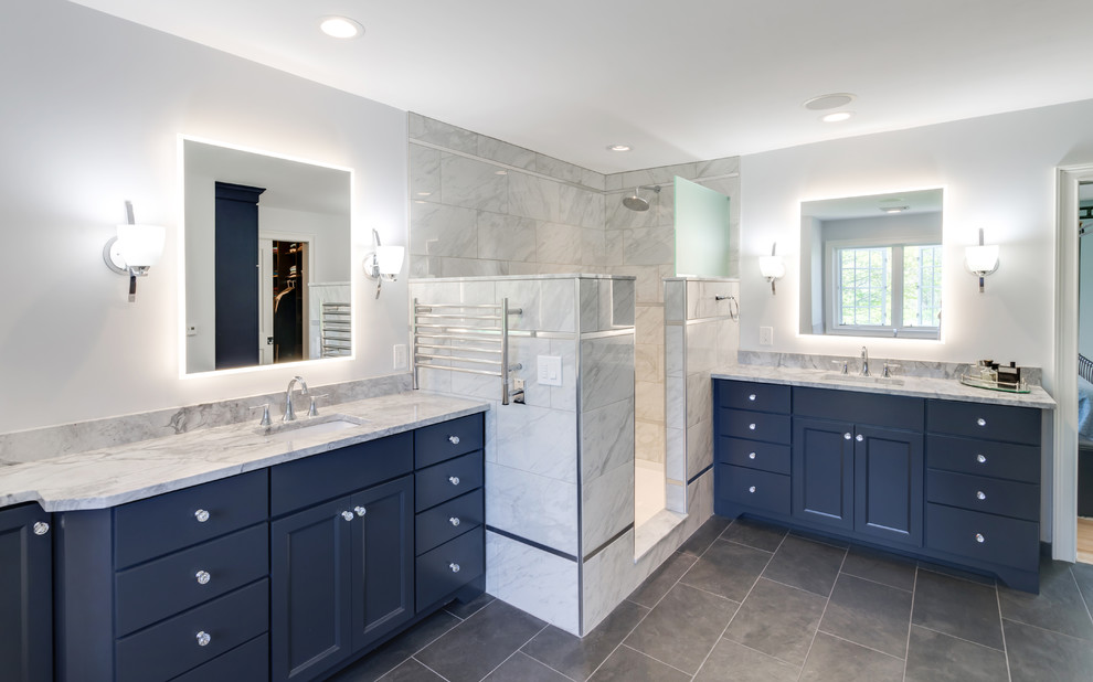 Large transitional master bathroom in Philadelphia with flat-panel cabinets, blue cabinets, a freestanding tub, an open shower, a two-piece toilet, gray tile, porcelain tile, grey walls, porcelain floors, an undermount sink, granite benchtops, grey floor, an open shower and grey benchtops.