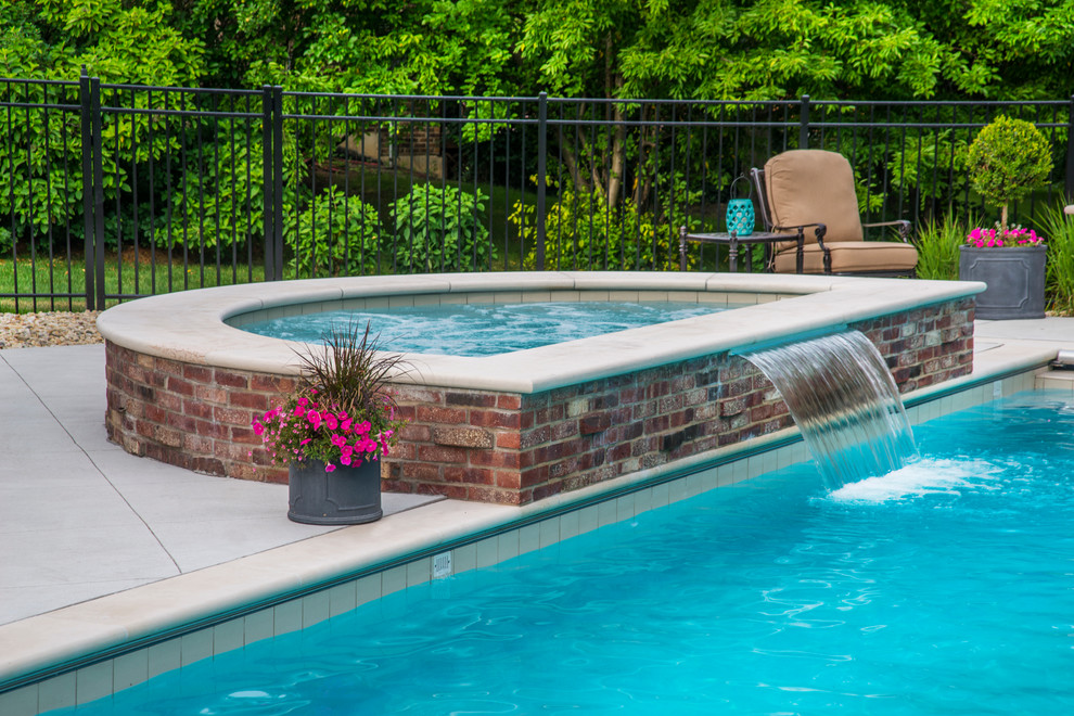 Mid-sized traditional backyard rectangular lap pool in Chicago with a hot tub and concrete slab.