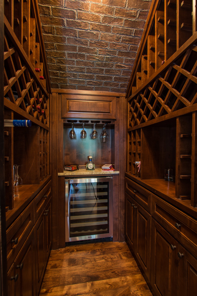 Inspiration for a traditional wine cellar in Austin with dark hardwood floors and storage racks.