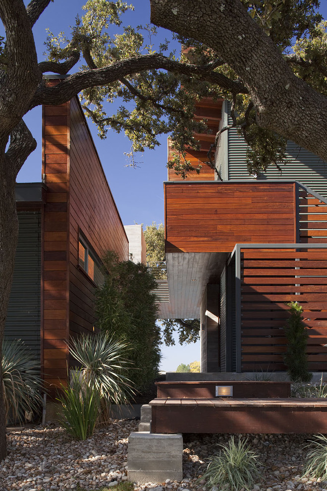 Large contemporary two-storey brown exterior in Austin with metal siding and a flat roof.