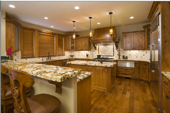 Inspiration for a mid-sized rustic u-shaped medium tone wood floor eat-in kitchen remodel with an undermount sink, shaker cabinets, medium tone wood cabinets, granite countertops, beige backsplash, ceramic backsplash, stainless steel appliances and an island
