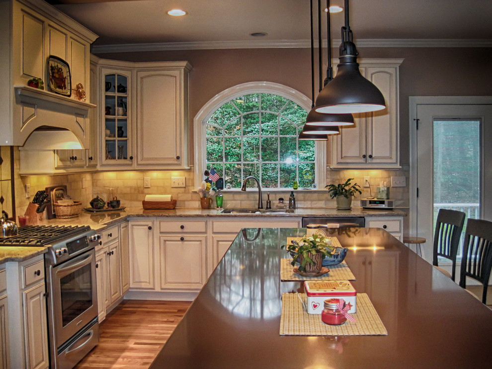 Large transitional l-shaped medium tone wood floor eat-in kitchen photo in Richmond with quartz countertops, a double-bowl sink, raised-panel cabinets, white cabinets, beige backsplash, stone tile backsplash, stainless steel appliances and an island