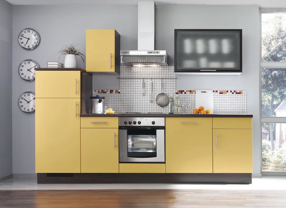 Design ideas for a small contemporary single-wall open plan kitchen in Other with a built-in sink, flat-panel cabinets, yellow cabinets, wood worktops, stainless steel appliances, no island and brown floors.