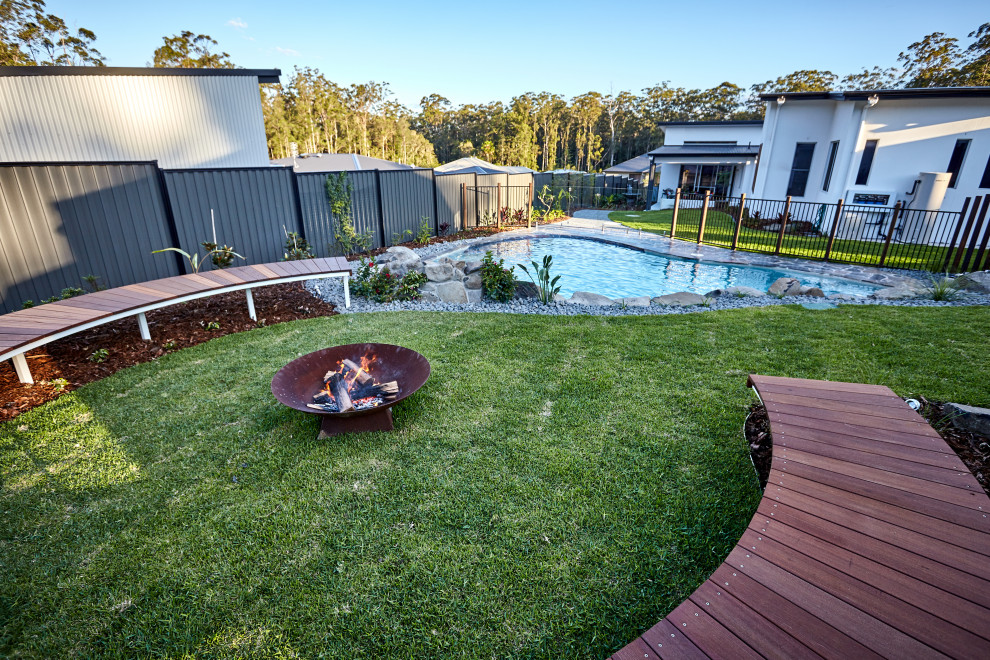 This is an example of a beach style backyard custom-shaped pool in Sunshine Coast.