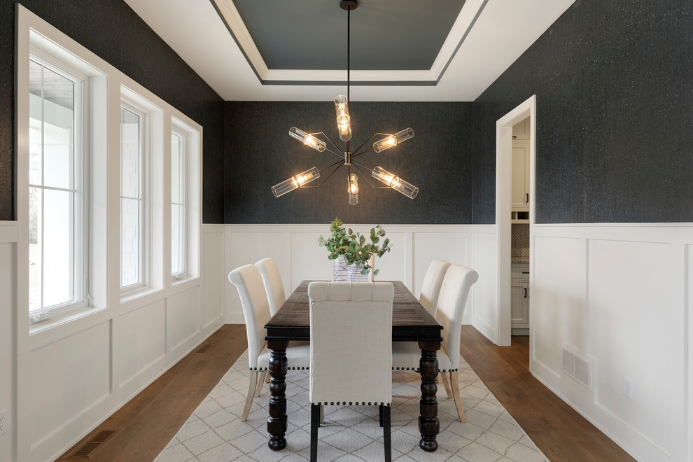 Inspiration for a large transitional separate dining room in Minneapolis with medium hardwood floors, no fireplace, brown floor and grey walls.