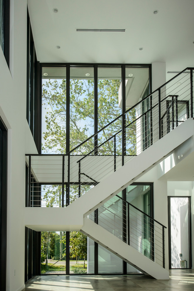 This is an example of a modern wood staircase in Miami with cable railing.