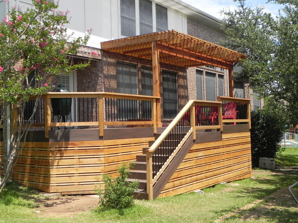 Photo of a large transitional backyard verandah in Austin with decking and a pergola.