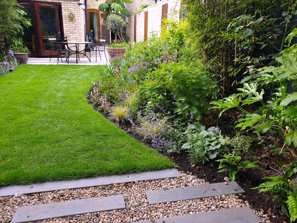 This is an example of a mid-sized contemporary drought-tolerant and partial sun backyard river rock garden path in Cambridgeshire.
