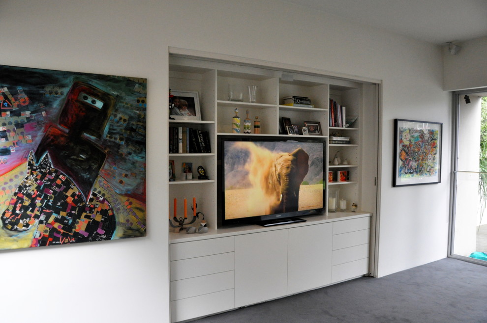 Photo of a mid-sized contemporary open concept living room in Melbourne with white walls, carpet and a built-in media wall.
