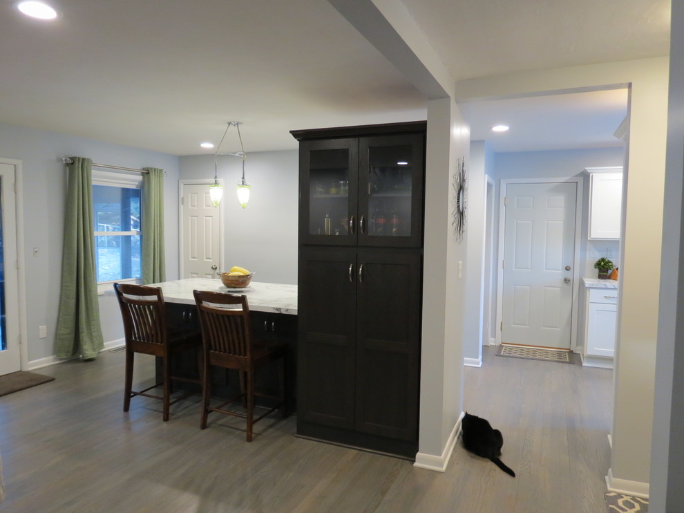 Mid-sized transitional light wood floor and brown floor kitchen/dining room combo photo with gray walls and no fireplace