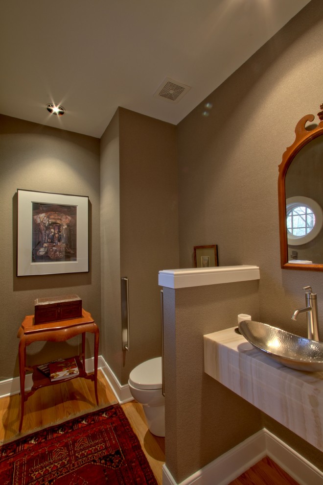 This is an example of a transitional powder room in Indianapolis with a vessel sink and onyx benchtops.